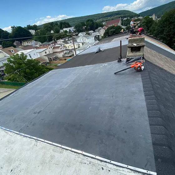 Roofer performing commercial flat roofing services