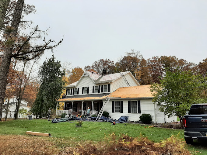 House During a New Shingle Roof Installation in Autumn