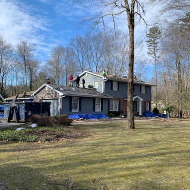 Symmetry's Roofing Team Doing a New Shingle Roof Installation on a Colonial House