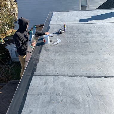 Roofing Contractor Installing New Commercial Flat Roof