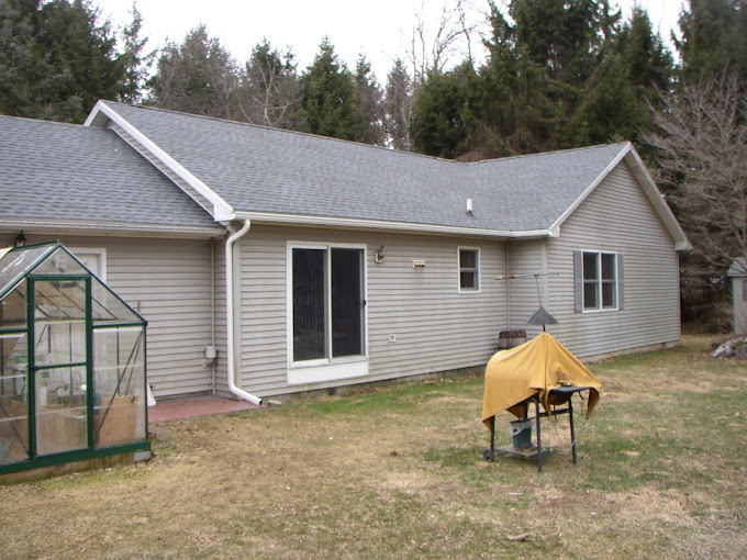 Rear View of Residential Ranch Home with New Shingle Roof