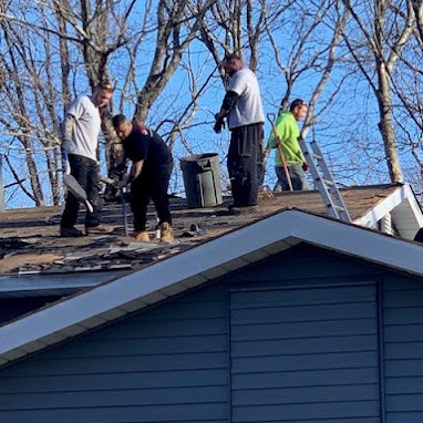 Four Roofers Remove Damaged Shingles During Shingle Roof Installation