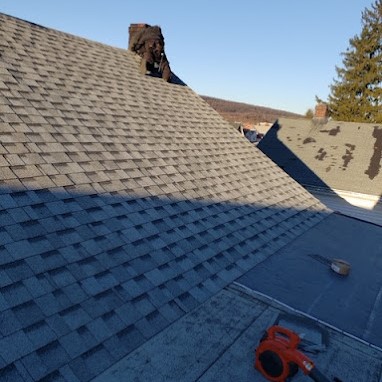 Roofing Contractors Finishing a New Shingle Roof Installation