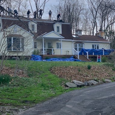 Symmetry's Roofing Team Removing Damaged Shingles for a Roof Replacement