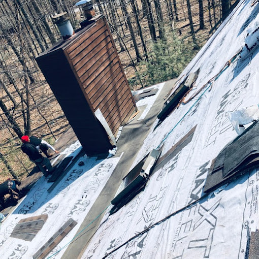 Roofing Contractors Working on a New Shingle Roof Repair with two Skylights and Chimney