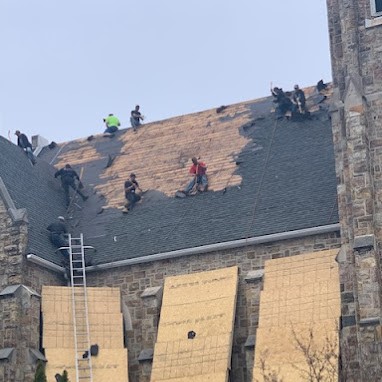 Symmetry's Roofing Contractor Team Removing Old Shingles of Stone Church in Preparation for Roof Replacement