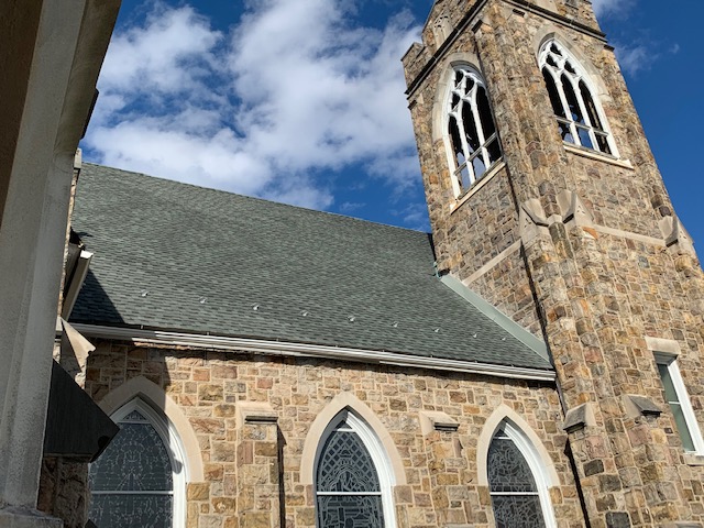 Stained Glass Stone Church with New Shingle Roof Replacement