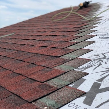 Partly Completed Red Shingle Roof Installation